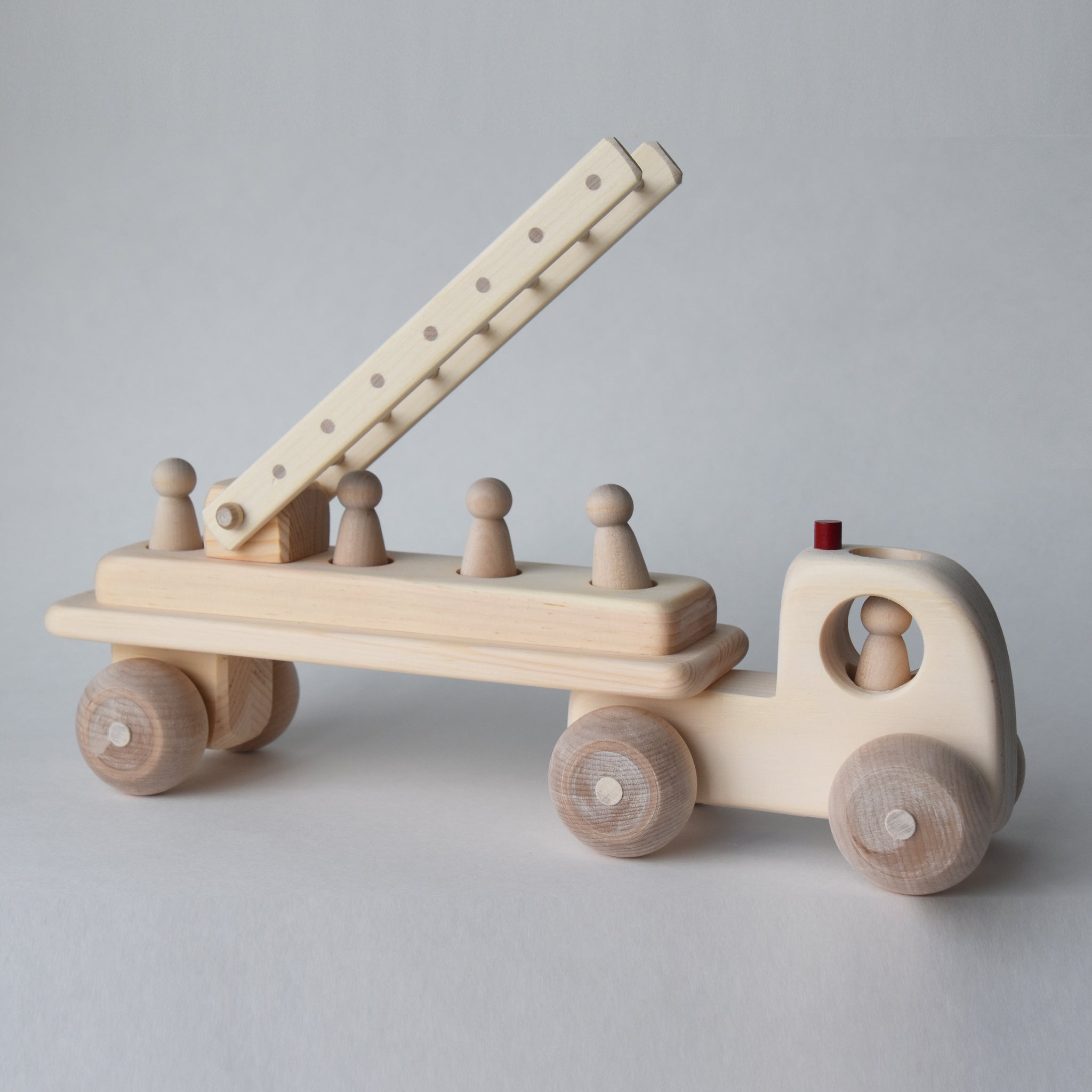 Handmade wooden fire engine toy with five removable peg people | Salt Air Supply